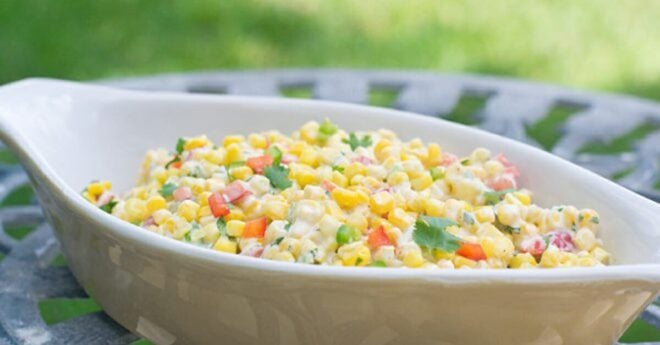 Creamy spicy corn salad in a white dish