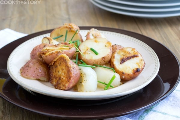 Parmesan Roasted Potatoes on a plate. topped with chives.