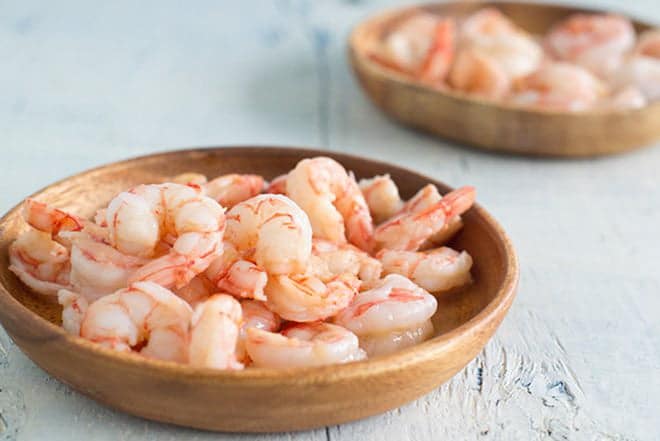 Cooked Royal Red shrimp in a low wooden bowl.