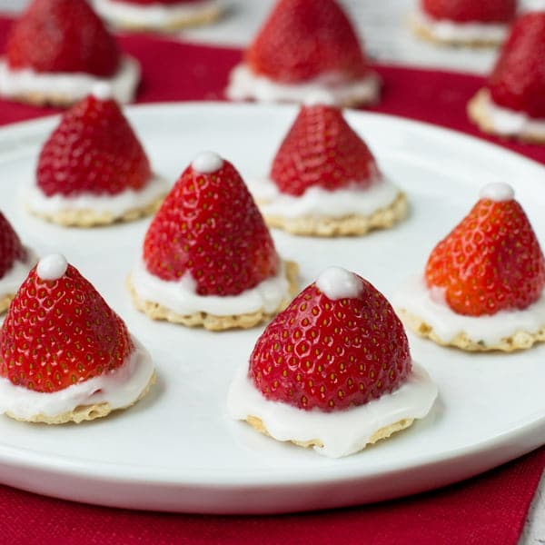 Strawberry Santa Hats on a white plate.