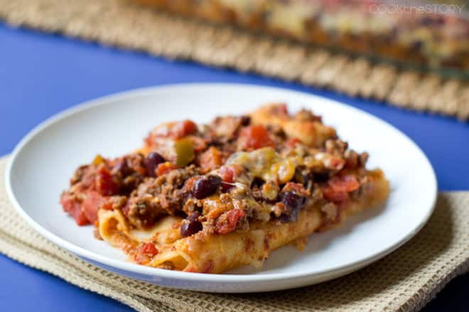 This Chili Enchiladas recipe is a cross of chili and enchiladas. You can use homemade chili, leftovers, or even store bought. Kids love this easy dinner!