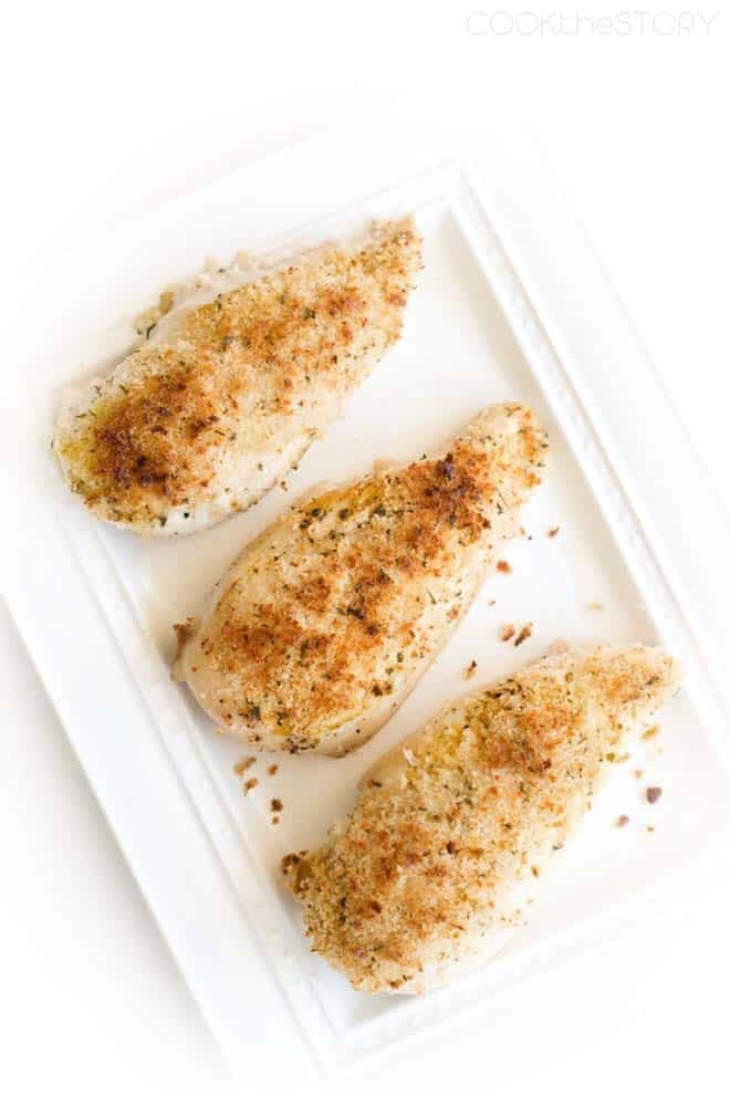 Breaded Chicken Breasts on white platter.