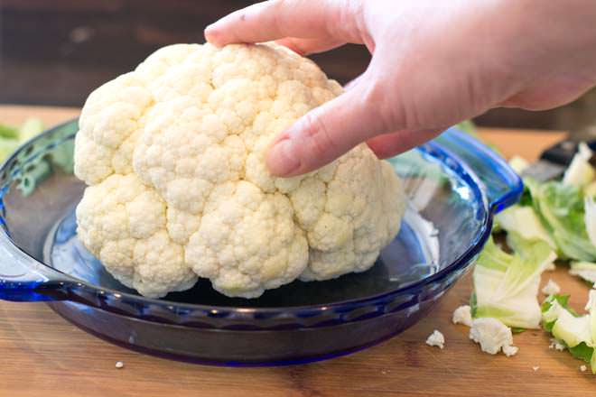 Head of cauliflower in blue pie dish.