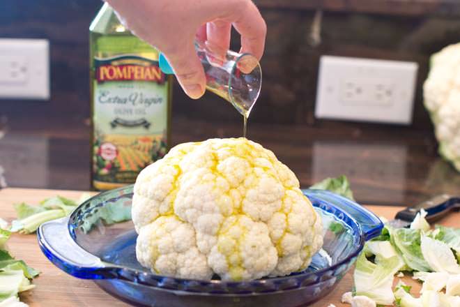 Oil being poured on top of the cauliflower.