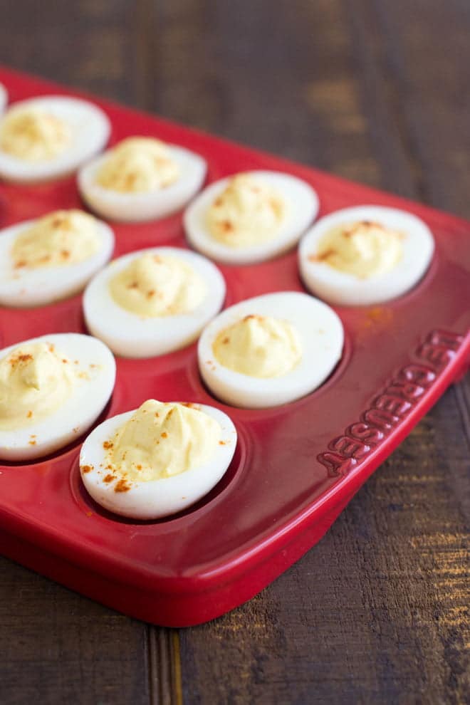 Perfect Deviled Eggs in a red serving dish.