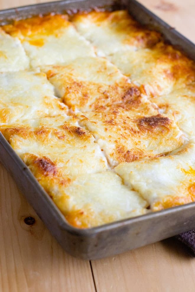 The Best Lasagna sliced into portions in a baking pan.