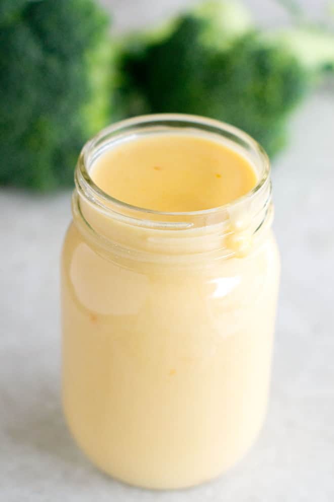 Mason jar filled with cheese sauce.