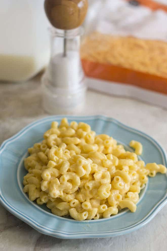 Homemade macaroni and cheese on a blue plate.