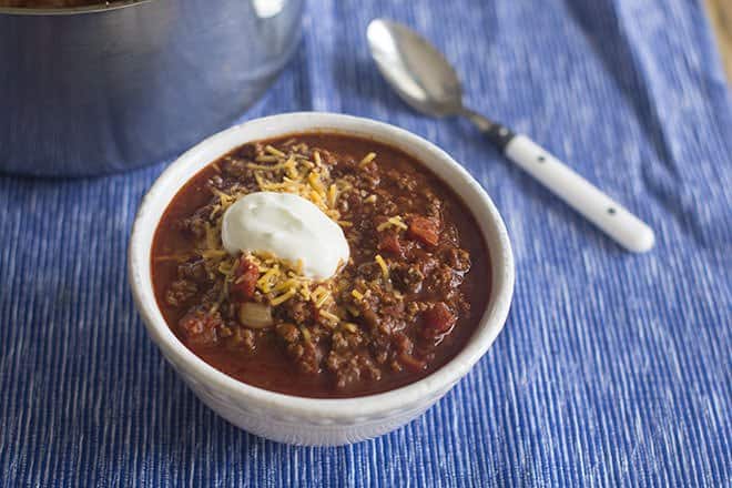 Chili Con Carne with shredded cheese and a dollop of sour cream.