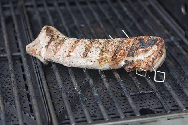 Pork tenderloin with grill marks on the grill.