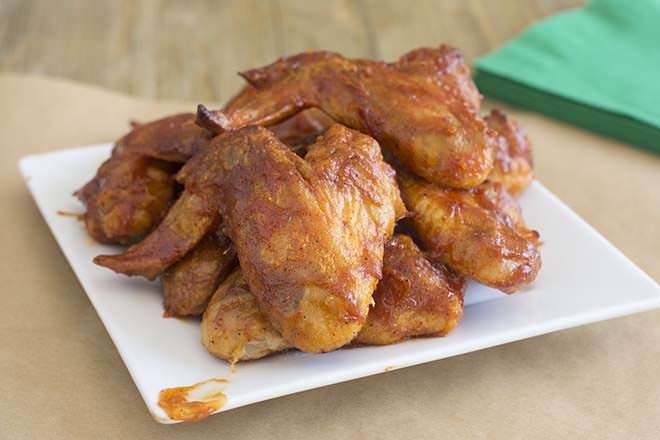 Ultimate BBQ Glazed Chicken Wings on a white plate.
