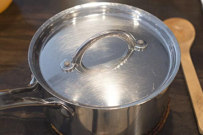 Saucepan with lid covering it.