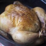 Whole uncooked chicken in a roasting pan