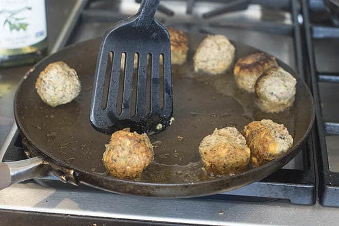 Turn meatballs with a spatula to cook other side.