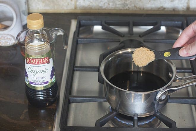 Adding brown sugar to pan of balsamic.