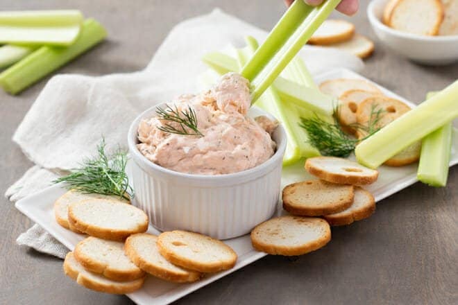 Smoked Salmon Dip in a small bowl. Toast rounds and celery around it.