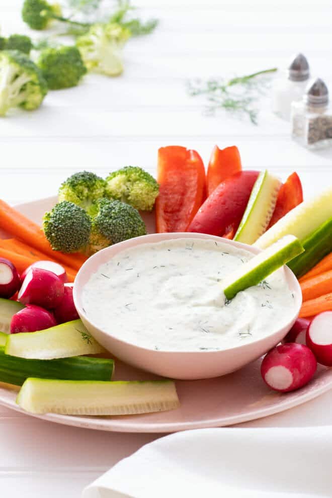 Ranch dip surrounded by fresh veggies.