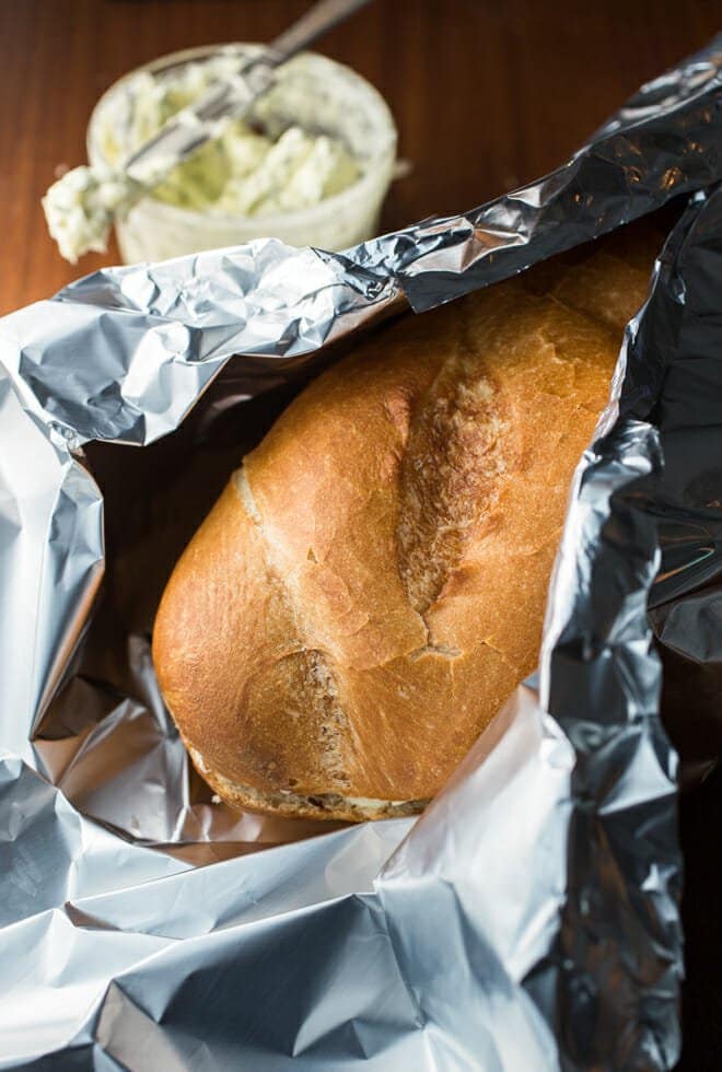 Loaf of bread being wrapped in foil.