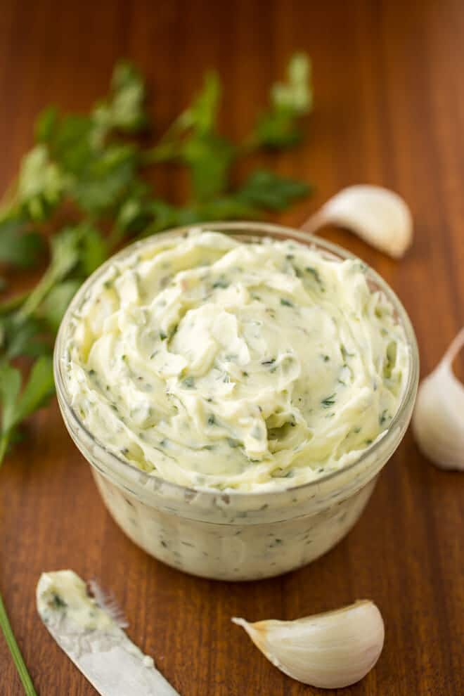 Small glass container with fresh garlic butter.