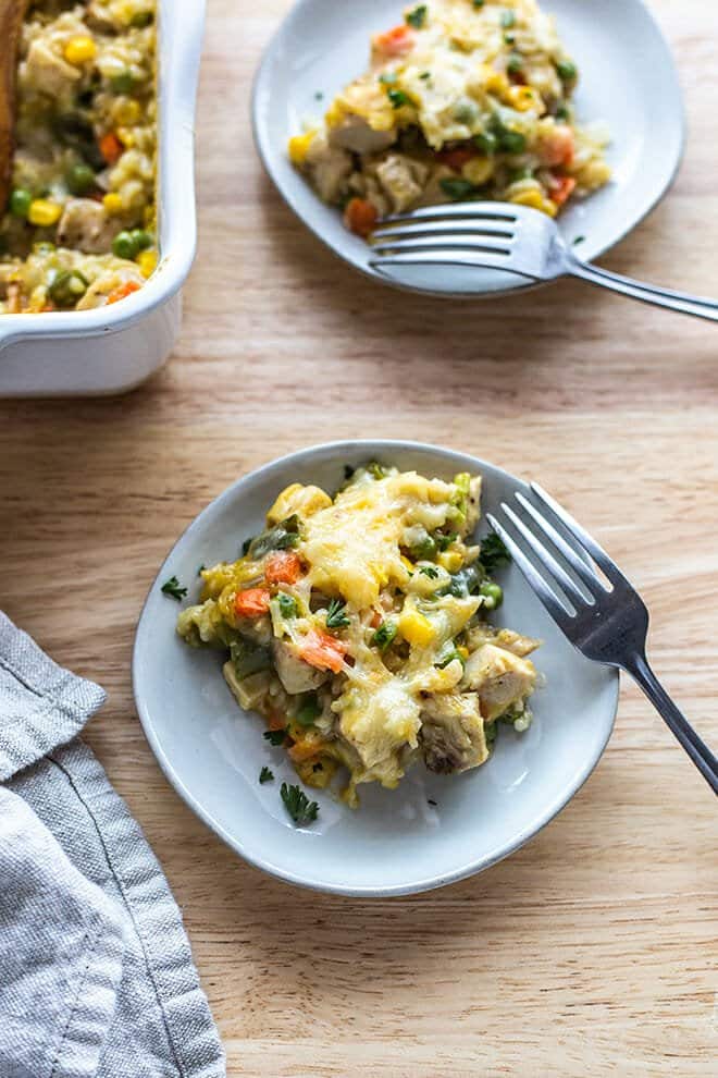 This classic Cheesy Chicken and Rice Casserole recipe is the comfort food at its finest. Chicken, rice, vegetables, cheese, and cream of chicken soup baked until bubbly and golden.