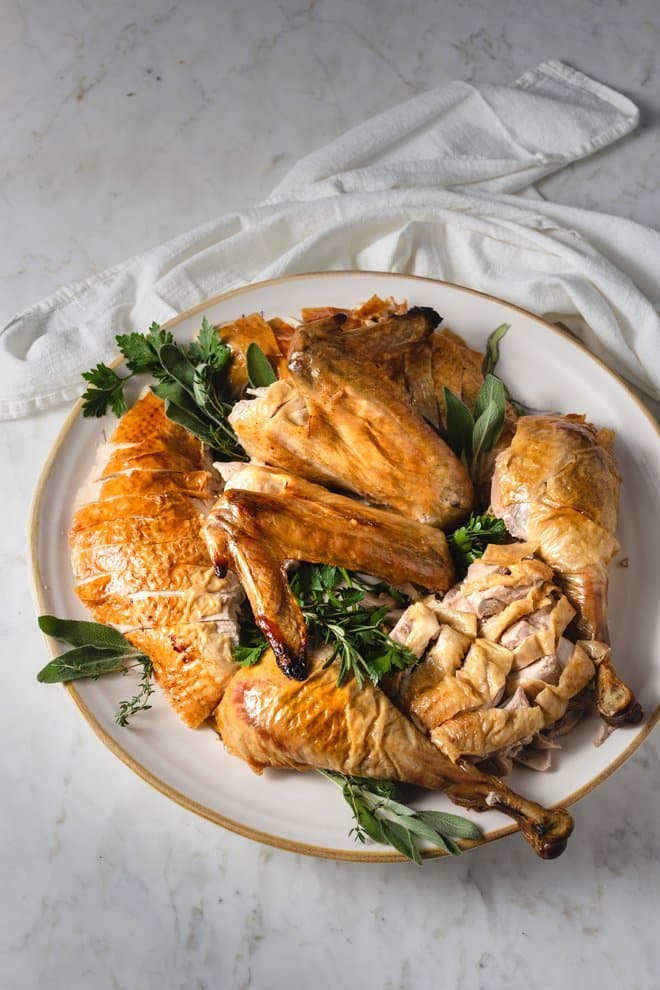 Carved turkey on a white platter.