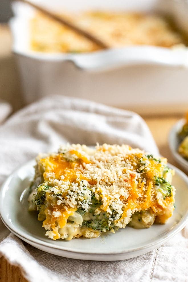 Broccoli Cheese Casserole with a crunchy topping on a light plate.