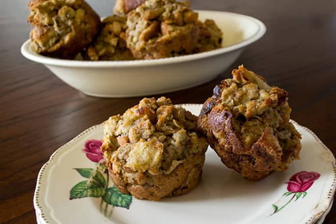 Stuffing muffins on a patterned plate.