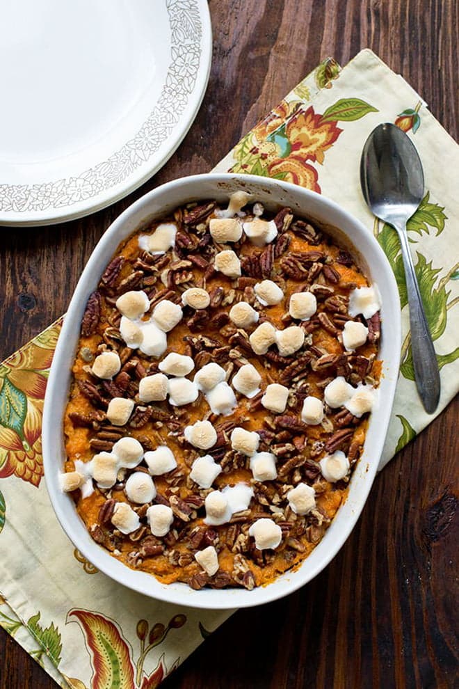 Sweet Potato Casserole topped with pecans and mini marshmallows.
