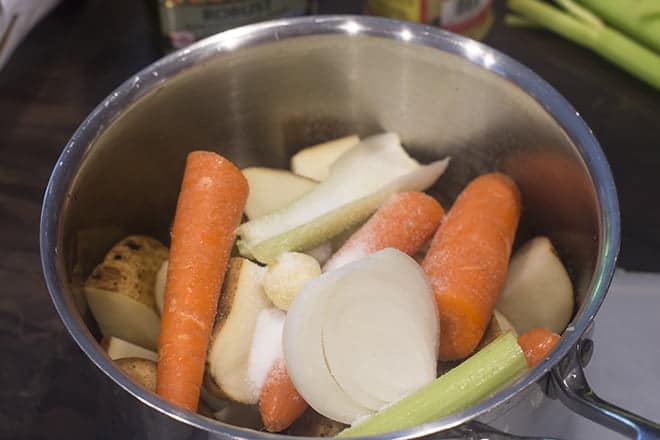 Potatoes, onion, carrots, celery in stock pot with salt.