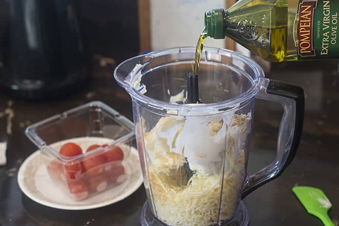 Drizzle olive oil in food processor with cheese.