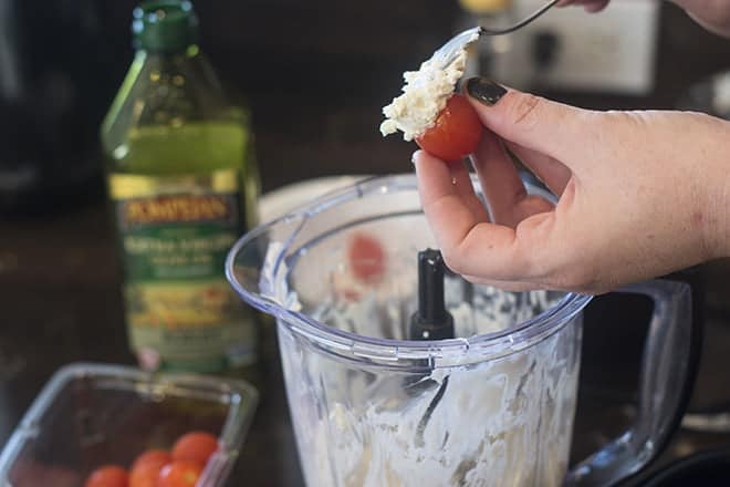 Use a spoon to gently fill each tomato with cheese mixture.