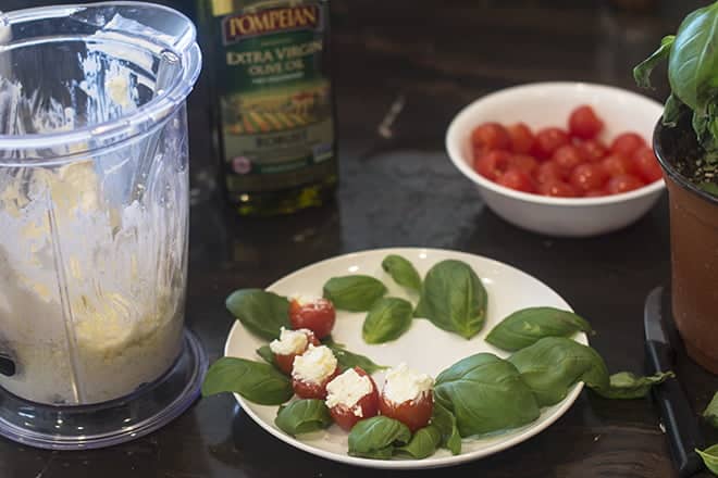 Top the ring of basil leaves with a ring of stuffed tomatoes.
