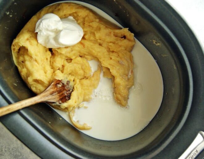 Overhead shot of mashed potatoes with milk and sour cream.