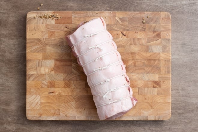 Stuffed pork loin rolled up and tied with kitchen twine.
