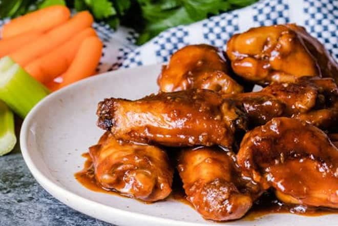 Chicken wings with sauce on a plate.