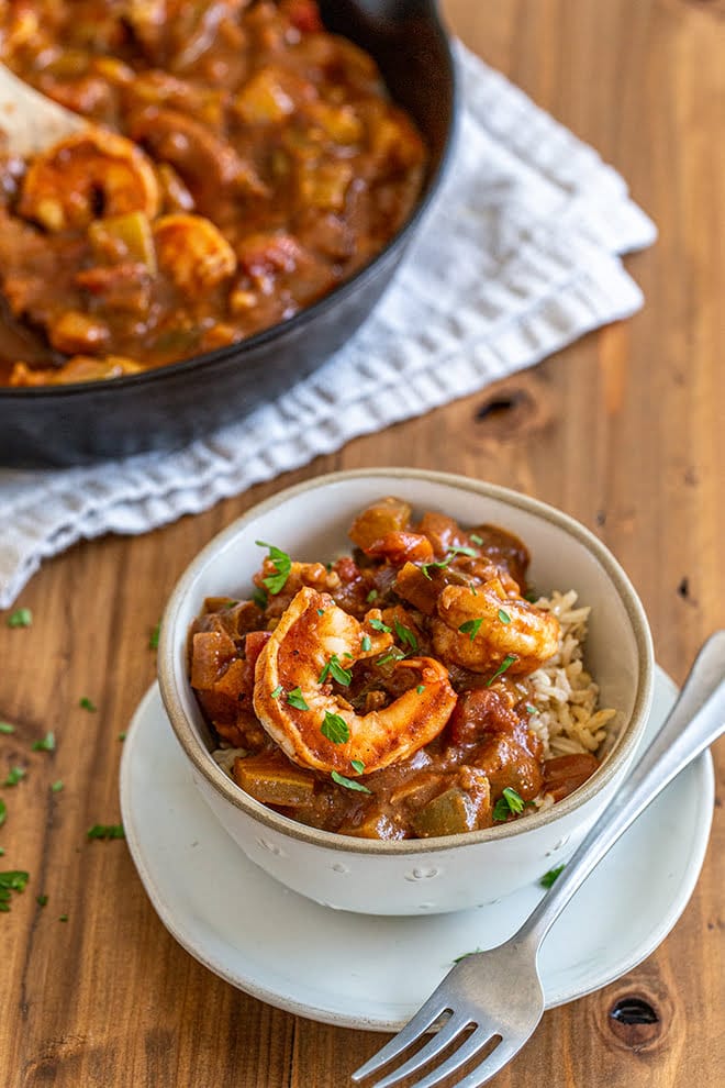 Shrimp Creole is a traditional Cajun dish that covers rice with shrimp cooked in a tomato based sauce with plenty of spices, onions, celery, and bell peppers.