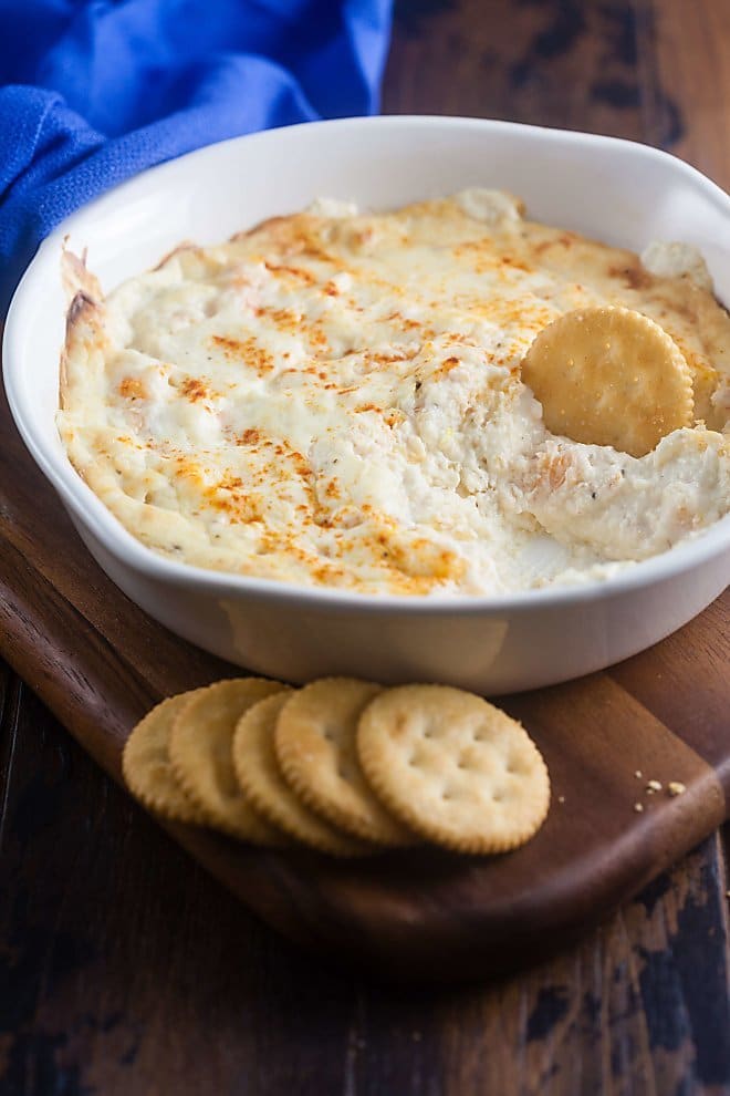 Cheesy Baked Shrimp Dip in a white dish with crackers.
