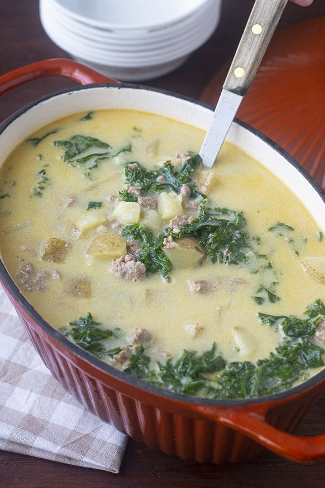 Bring Olive Garden home with this delicious Zuppa Toscana - a creamy soup with Italian sausage, potatoes, and kale!