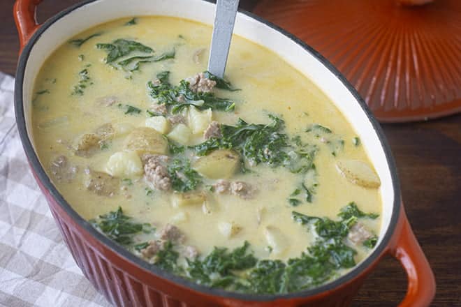 Zuppa Toscana in a large burnt orange oval dish.