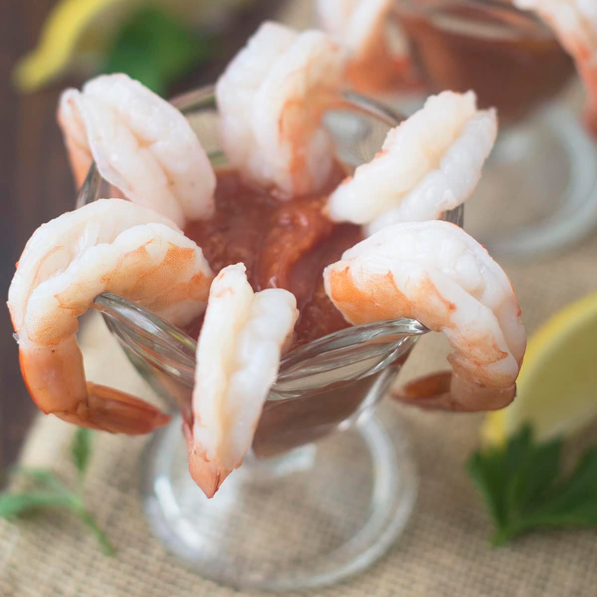 Classic shrimp cocktail served in a glass.