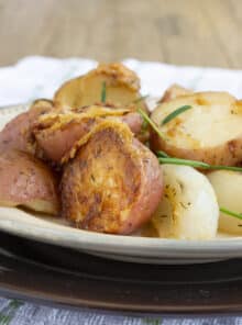 Red potatoes, onion pieces, all with a crispy Parmesan crust, garnished with chives