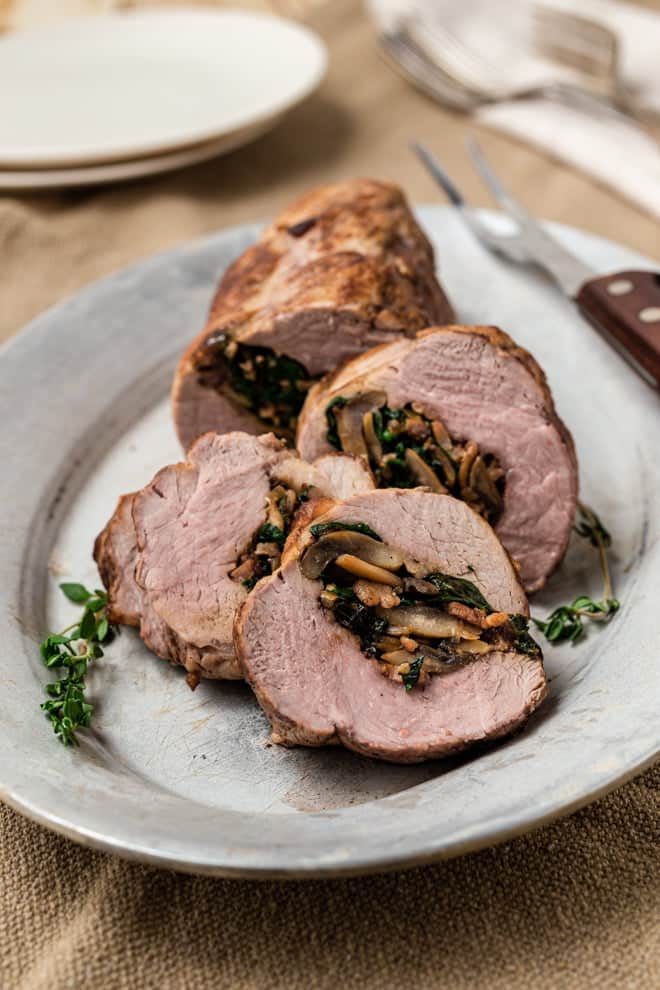 Slices of pork tenderloin with a stuffing of spinach, mushrooms, bacon, and Parmesan cheese.
