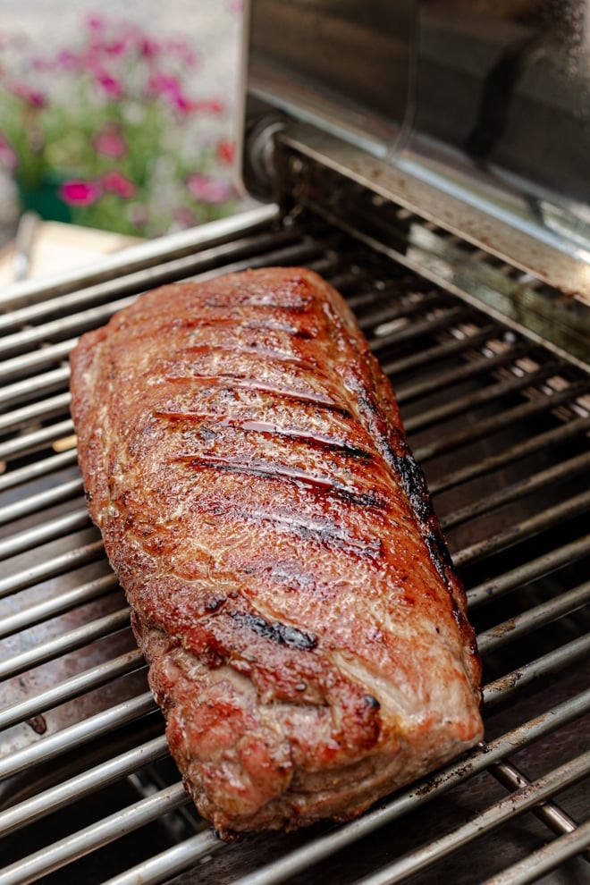Pork Loin on a grill with crispy exterior and grill marks.