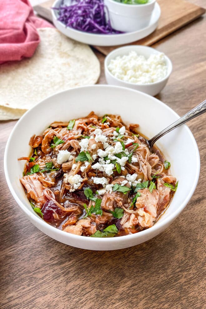 Cranberry Chipotle Pulled Chicken in a white bowl with bowl.