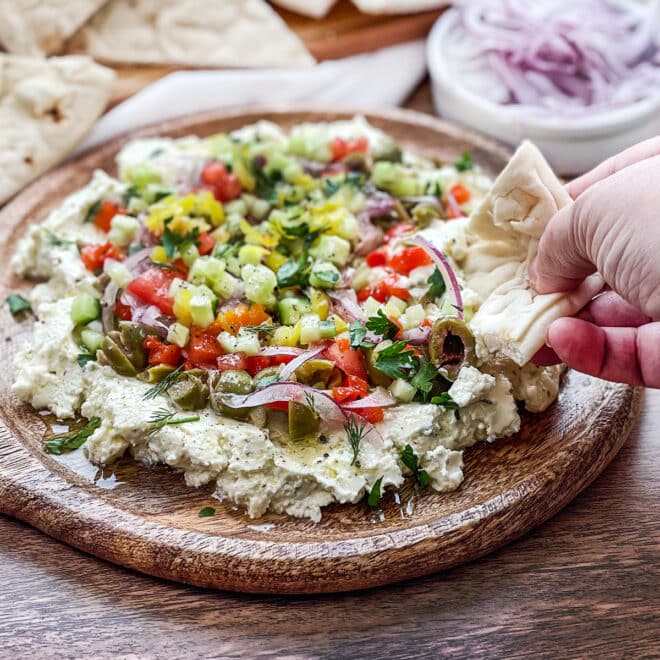 Whipped feta dip topped with olives, red onion, cucumber, and more.