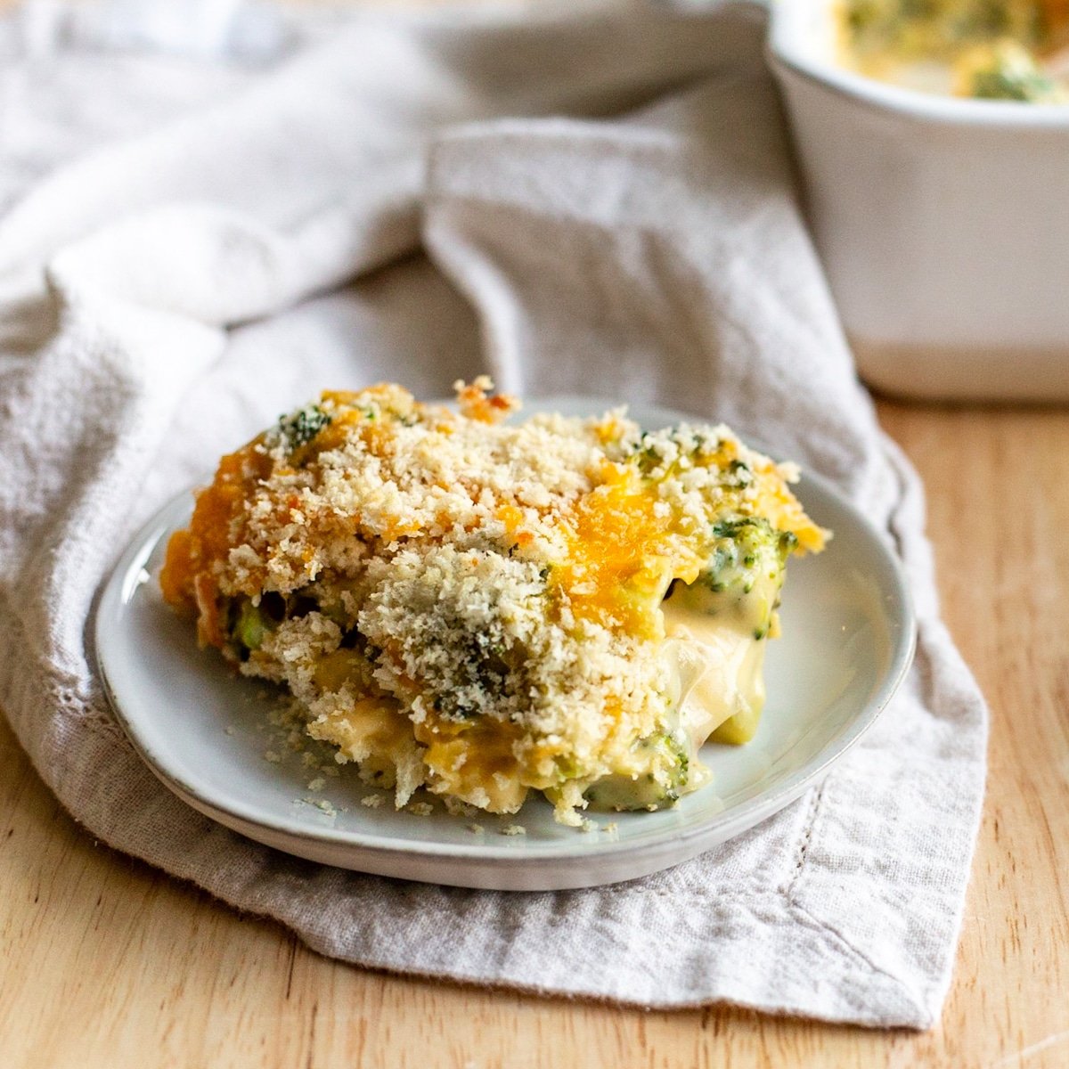 Plate of broccoli cheese casserole with panko topping.