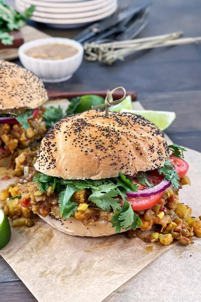 Indian spiced lentil sloppy joes on buns with cilantro, red onion, and tomato.