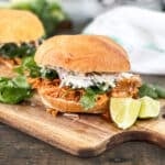 thai curry pulled chicken with slaw and cilantro on a sandwich roll