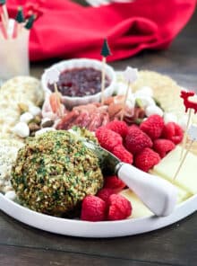 Christmas charcuterie board with pistachio cheese ball, fresh raspberries, and more.