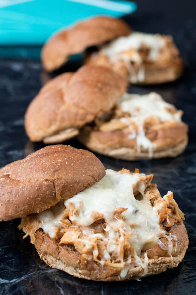 BBQ pulled chicken sandwiches with melted mozzarella cheese.